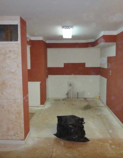 A room being remodeled with red and white walls.