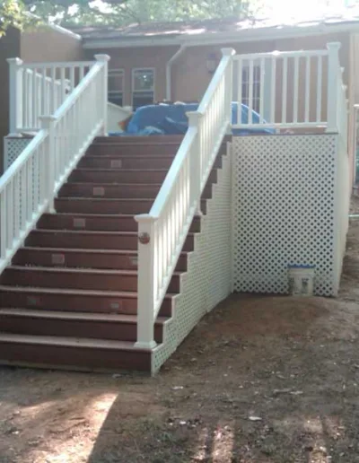 A white stairway leading up to a house.