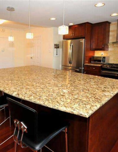 A kitchen with granite counter tops and stainless steel appliances.