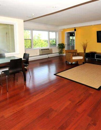 A living room with hardwood floors and a tv.