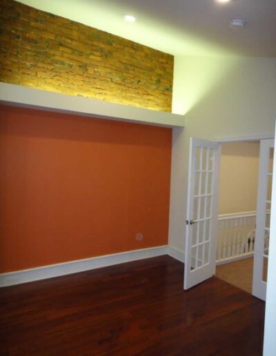 An empty room with a brick wall.