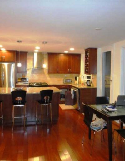 A kitchen with hardwood floors and a dining table.